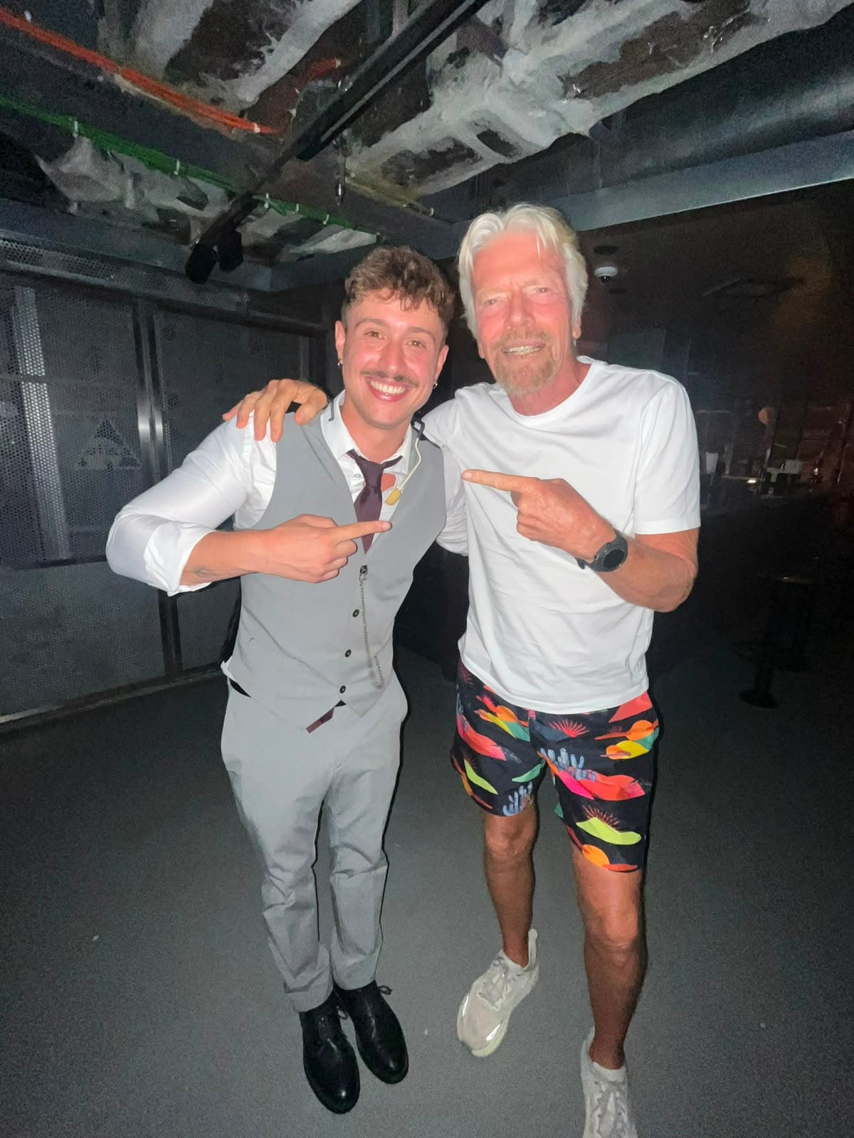 David Maestro posing with Sir Richard Branson backstage at a Virgin Voyages theatre after the show.